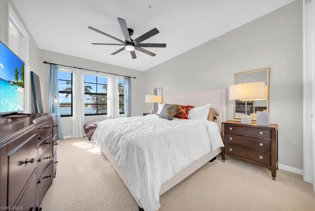 a spacious bedroom with a bed and a flat screen tv