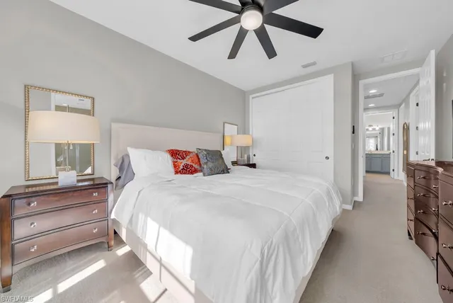 a bedroom with bed and a chandelier