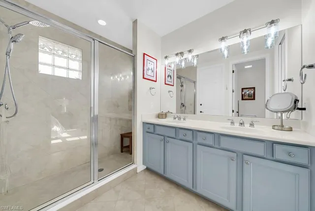 a bathroom with a double vanity sink mirror and double