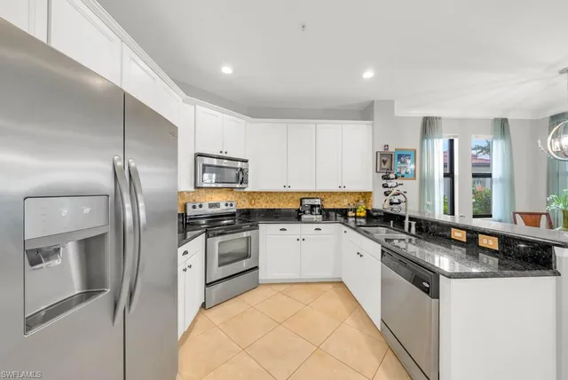 a kitchen with granite countertop stainless steel appliances and wooden cabinets