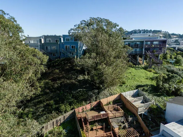 an aerial view of a house with yard and outdoor seating
