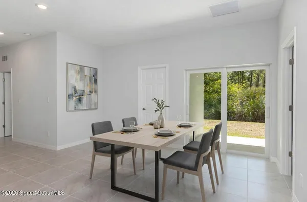 a dining room with furniture and window
