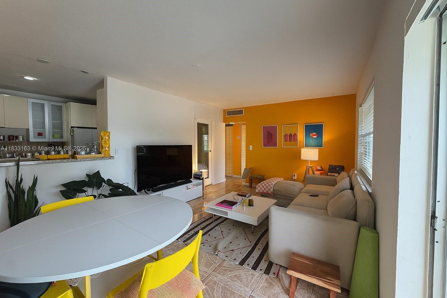 13101 Memorial Highway, Unit 215 Miami, FL 33161 - Photo 2 of 13 a living room with furniture and a flat screen tv