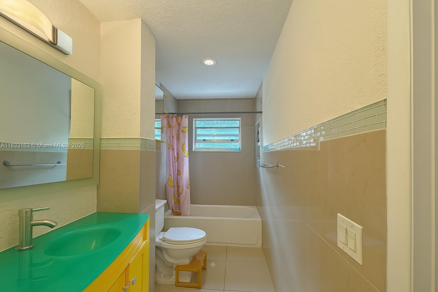 13101 Memorial Highway, Unit 215 Miami, FL 33161 - Photo 9 of 13 a bathroom with a sink a toilet and shower