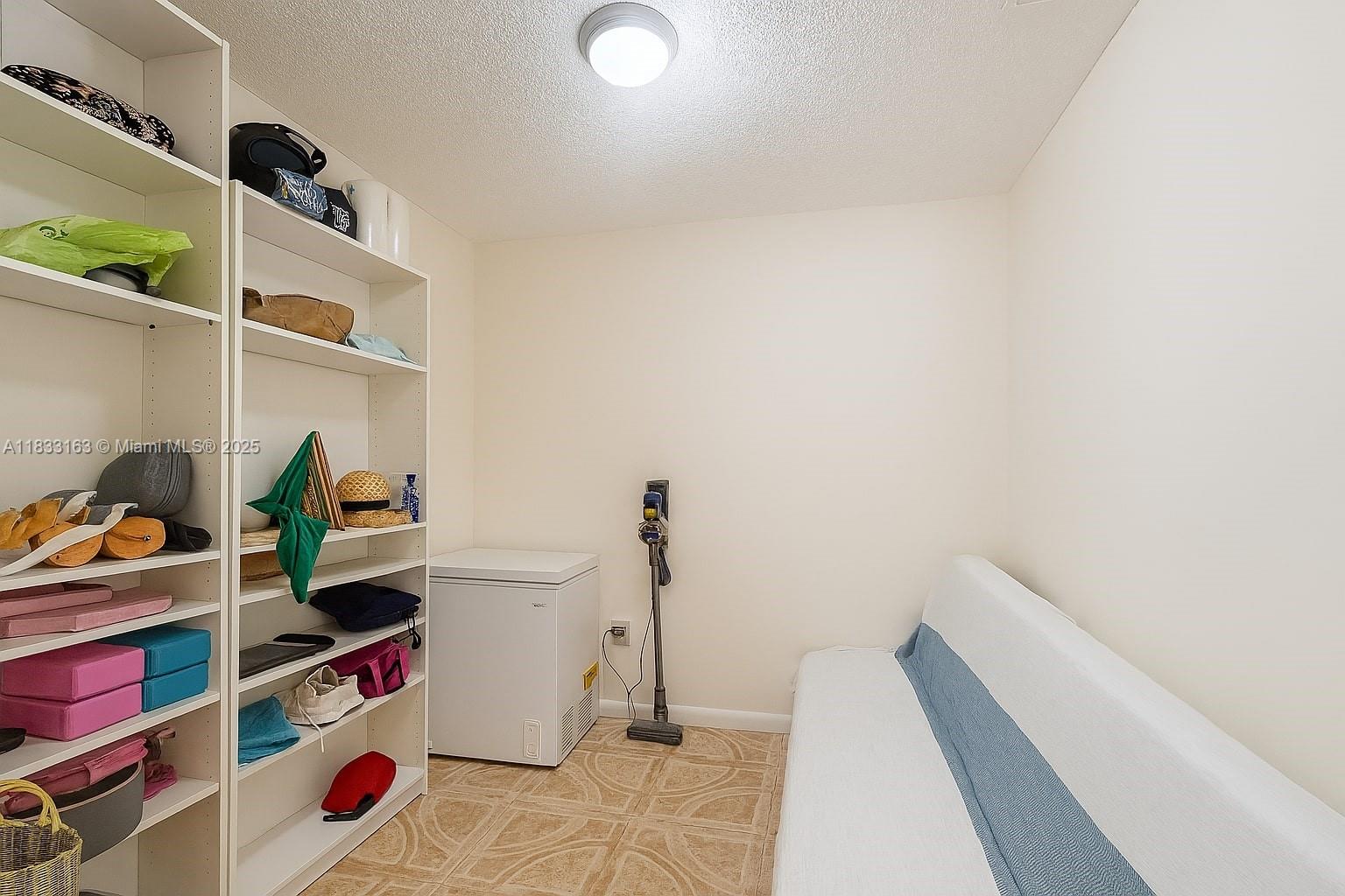 13101 Memorial Highway, Unit 215 Miami, FL 33161 - Photo 10 of 13 a view of walk in closet with clothes and shoes