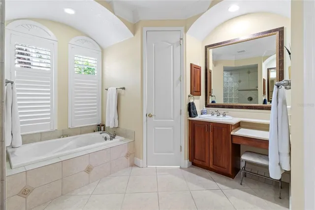 a spacious bathroom with a bathtub and a sink