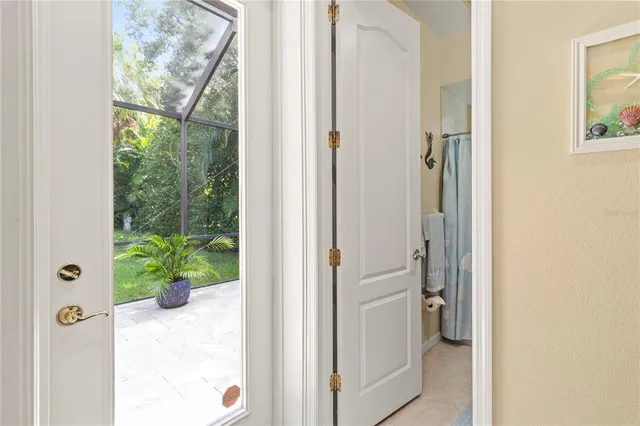 a view of a walk in closet and a bathroom