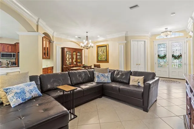 a living room with furniture and a chandelier