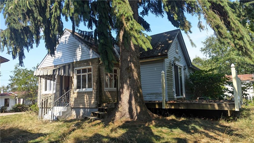 a view of a house with pool and sitting area