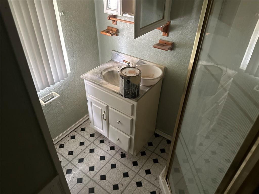 1034 Logan Road North Versailles, PA 15137 - Photo 12 of 18 a bathroom with a sink a toilet and shower curtain