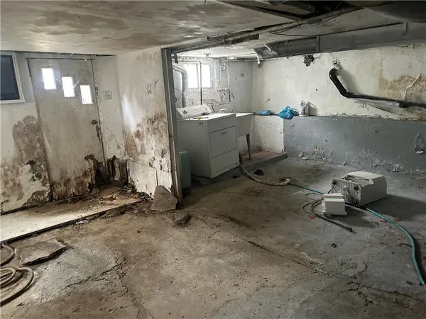 a room with water heater and a cabinet