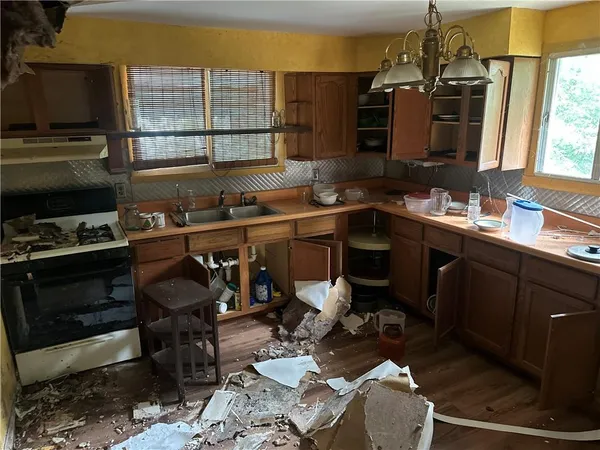 a kitchen with a sink appliances and a counter top space