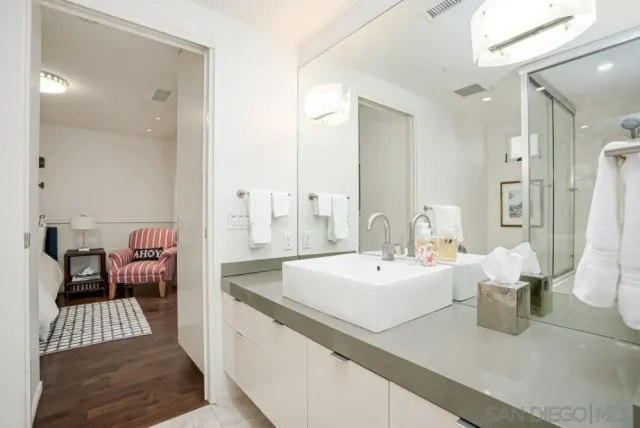 a large white room with a large mirror vanity and toilet