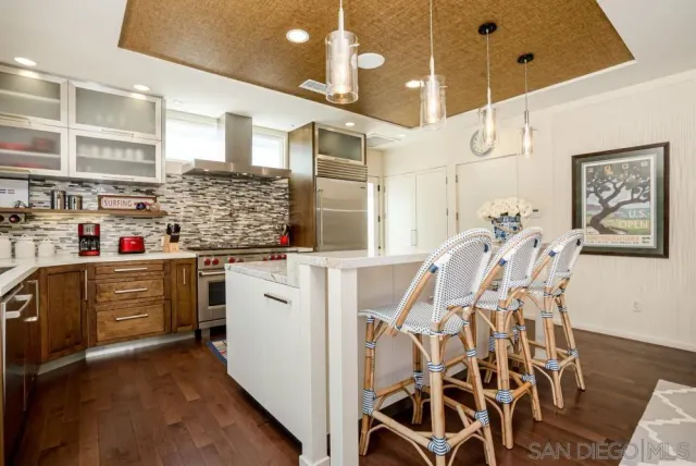 a kitchen with stainless steel appliances kitchen island granite countertop a refrigerator and microwave