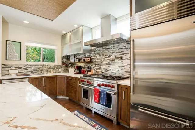 a kitchen with stainless steel appliances granite countertop a stove and a sink
