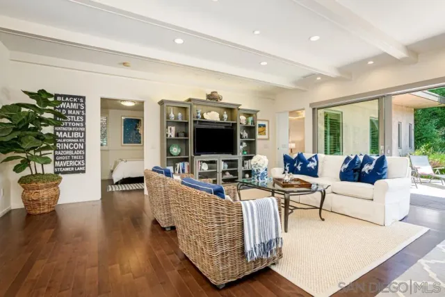 a living room with fireplace furniture and a flat screen tv