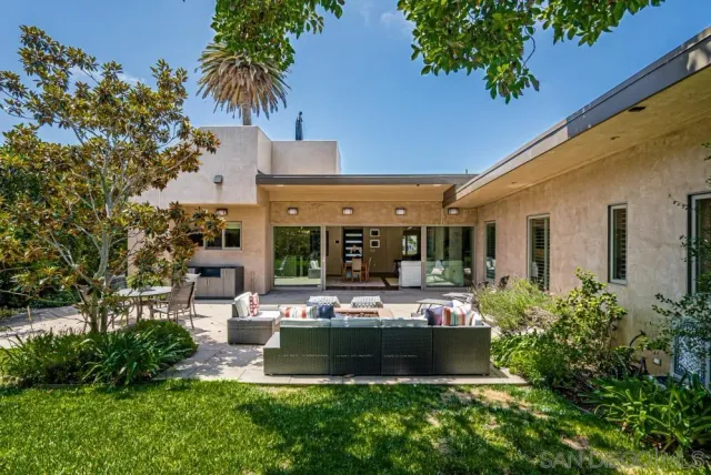 a view of a house with swimming pool and sitting area