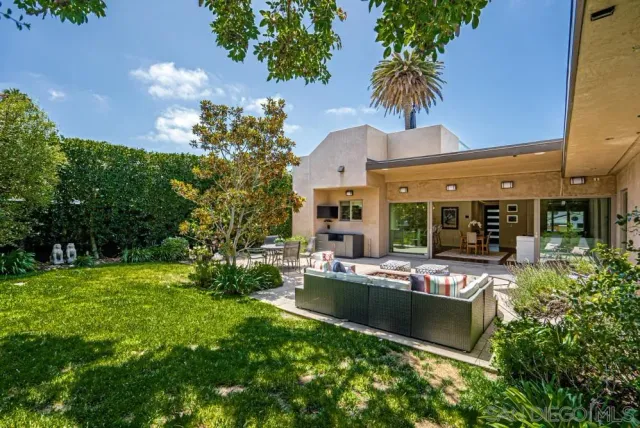 a view of a house with patio outdoor kitchen and swimming pool