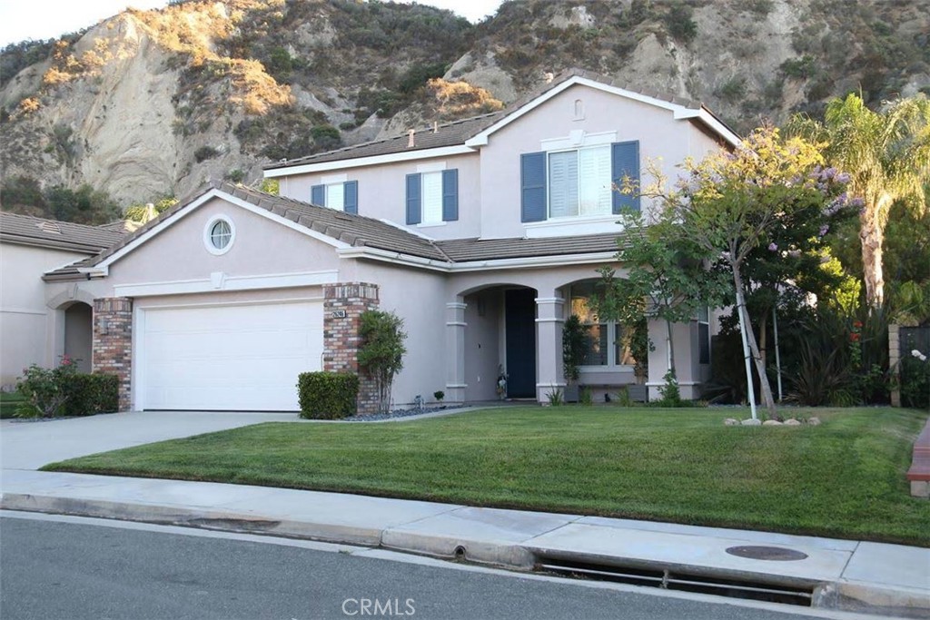 a front view of a house with a yard and garage