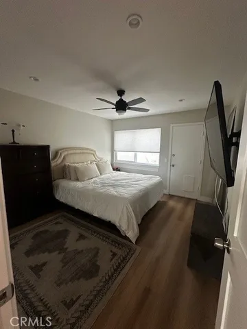 a bedroom with a bed and a television