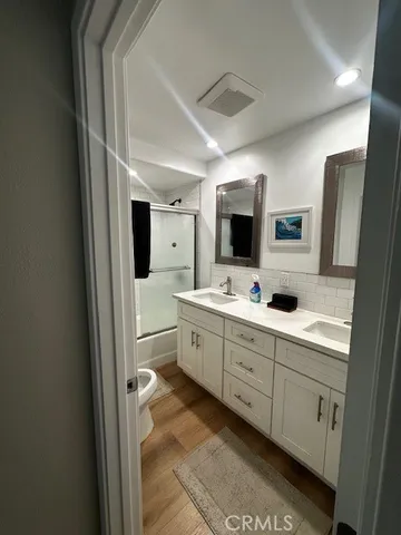 a bathroom with a double vanity sink and mirror