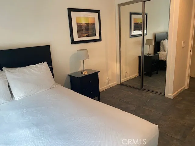 a bedroom with a bed and a lamp on table