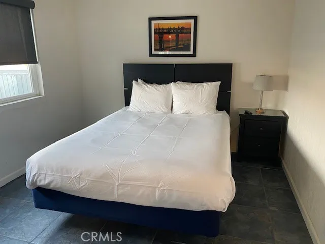 a large bed sitting in a bedroom next to a lamp