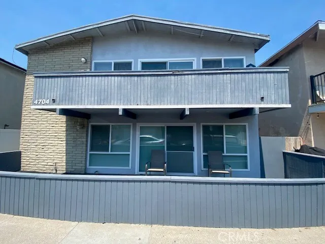 a view of a house with wooden fence