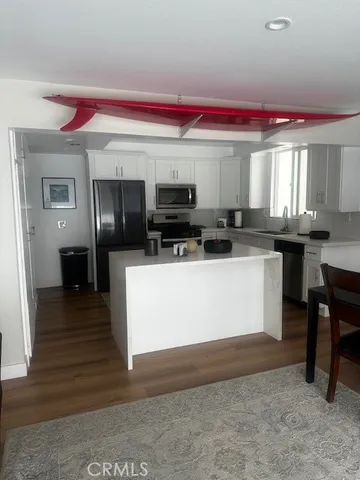 a kitchen with stainless steel appliances kitchen island granite countertop a stove a sink and a microwave