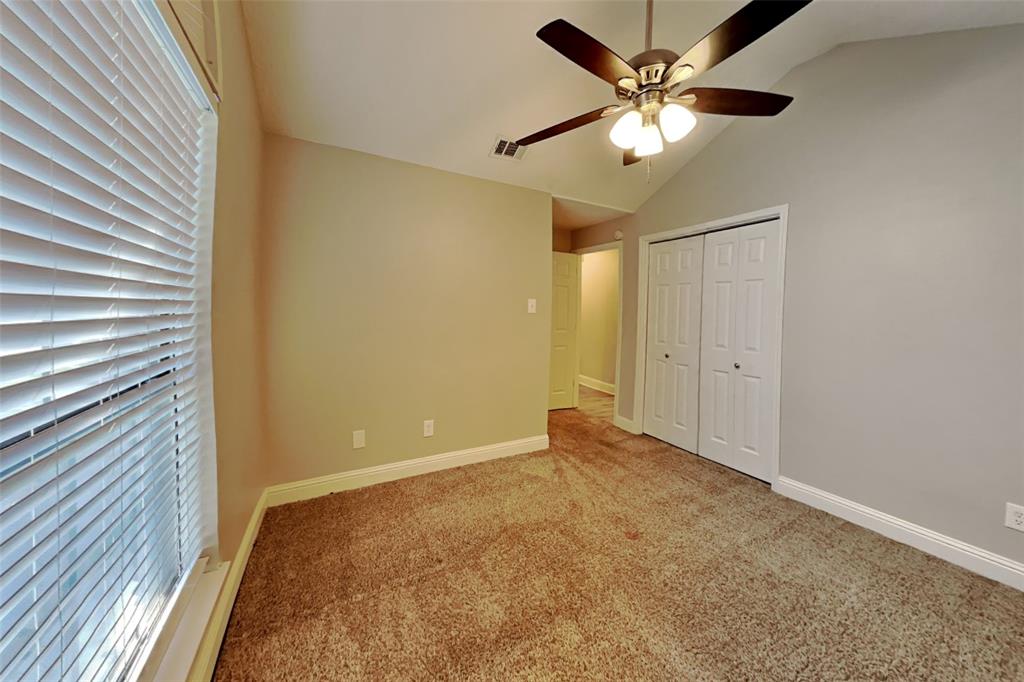 1009 Schrade Trail Mesquite, TX 75181 - Photo 12 of 19 Unfurnished bedroom with carpet flooring, lofted ceiling, a closet, and a ceiling fan