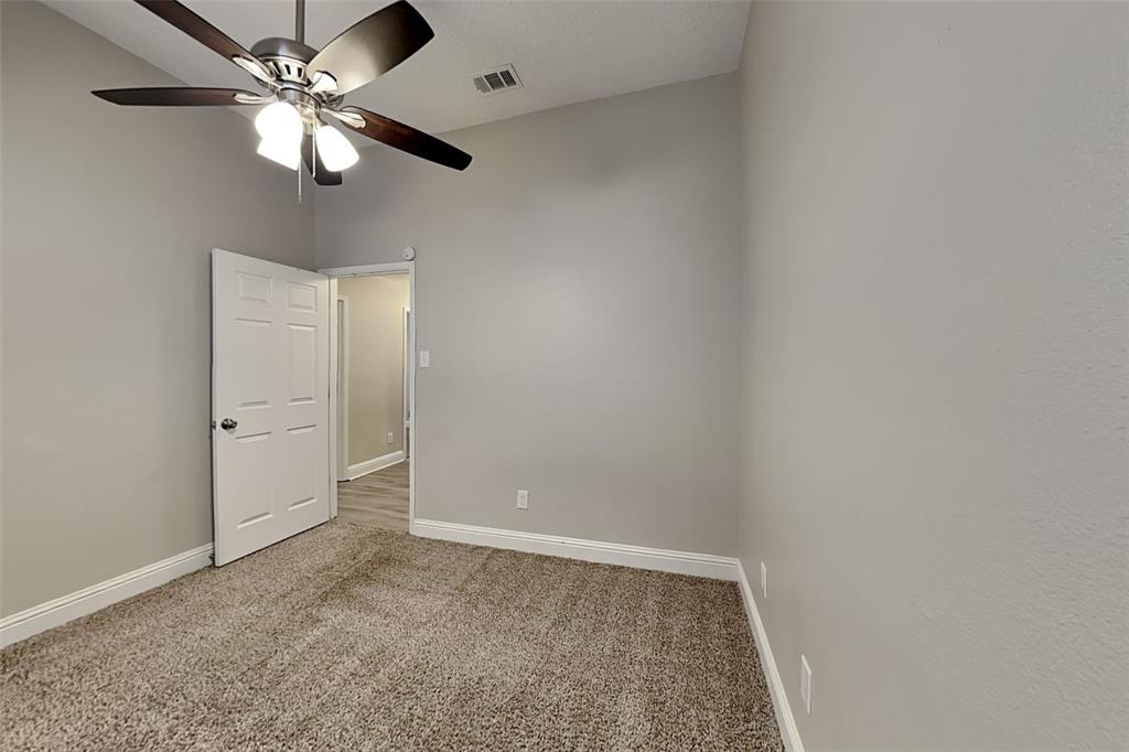 1009 Schrade Trail Mesquite, TX 75181 - Photo 14 of 19 Carpeted empty room with baseboards and ceiling fan