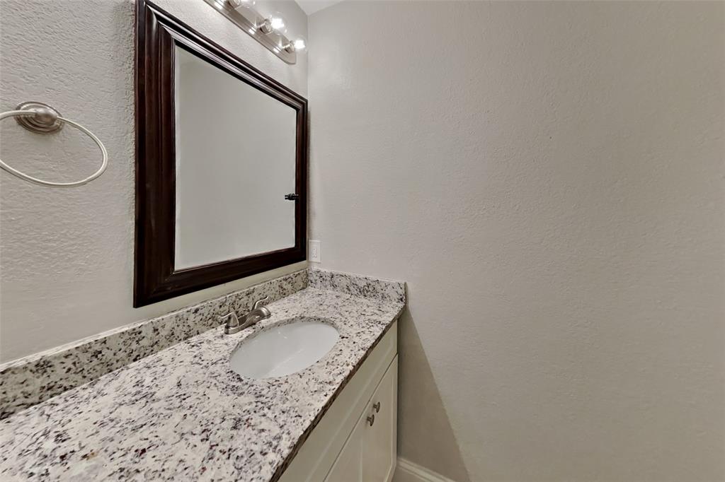 1009 Schrade Trail Mesquite, TX 75181 - Photo 15 of 19 Bathroom featuring a textured wall and vanity