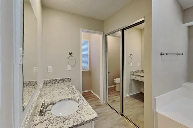 a en suite bathroom with a granite countertop sink mirror and shower