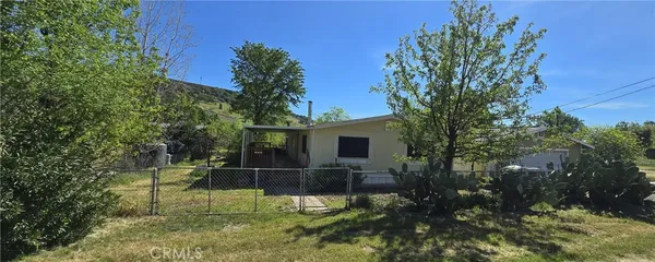 a view of a chair and tables in the backyard of the house