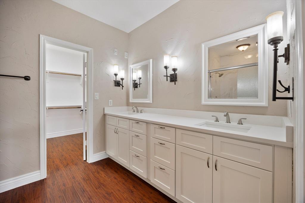 1908 Signal Ridge Place Rockwall, TX 75032 - Photo 12 of 28 a bathroom with a double vanity sink and mirror
