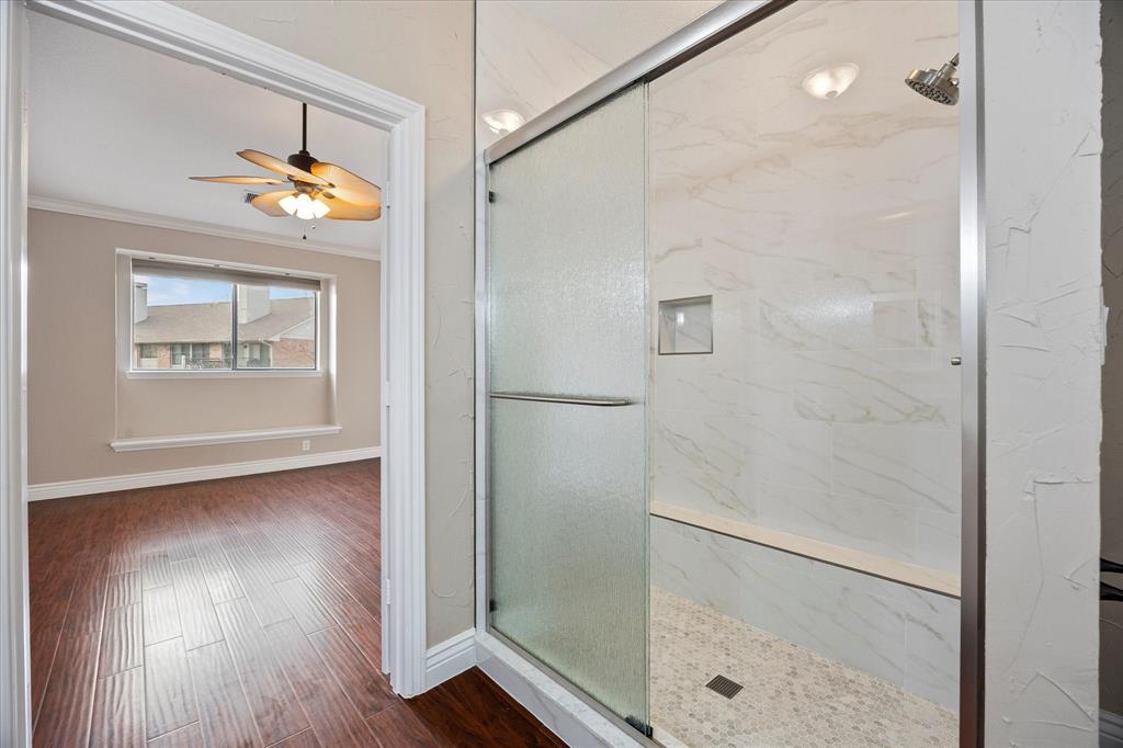 1908 Signal Ridge Place Rockwall, TX 75032 - Photo 13 of 28 a bathroom with a granite countertop shower a sink and a mirror