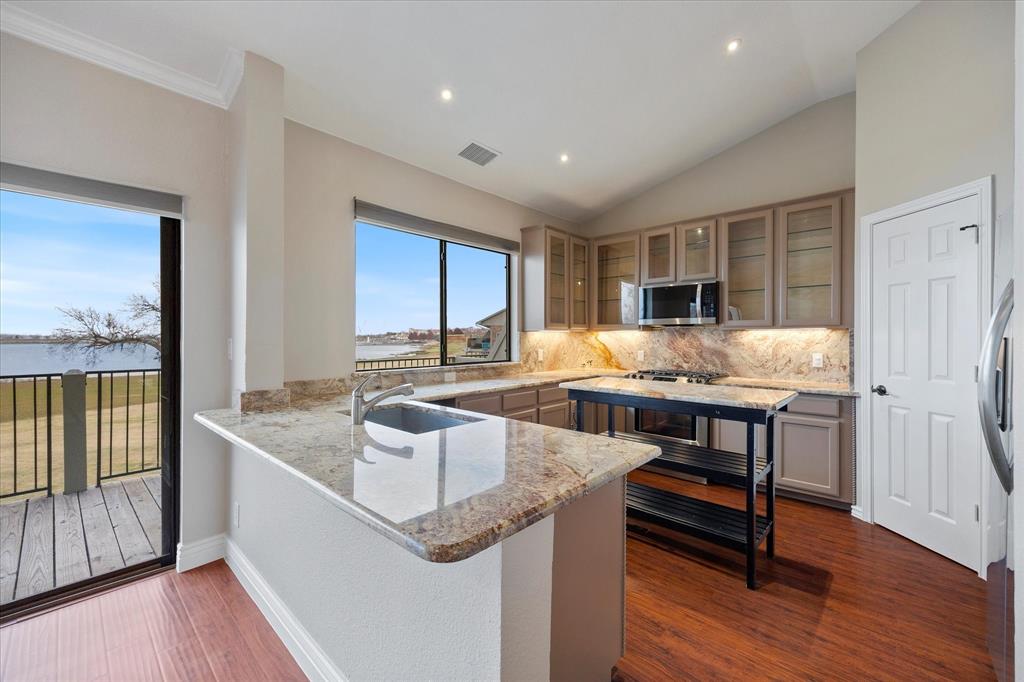 1908 Signal Ridge Place Rockwall, TX 75032 - Photo 4 of 28 a kitchen with granite countertop a sink and counter space