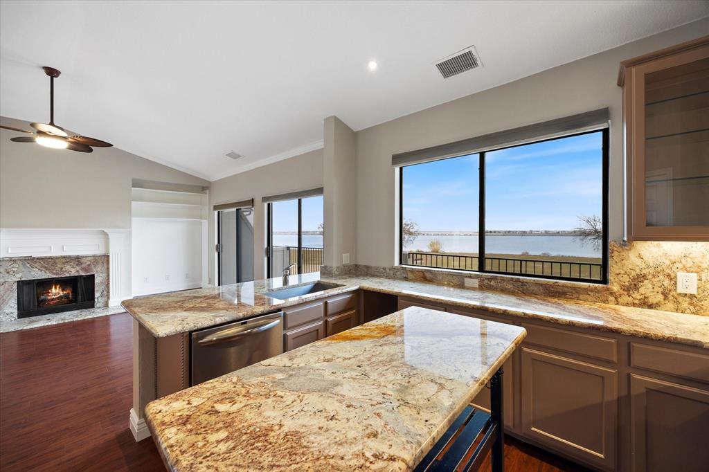 1908 Signal Ridge Place Rockwall, TX 75032 - Photo 5 of 28 a kitchen with a stove a sink and a wooden floors