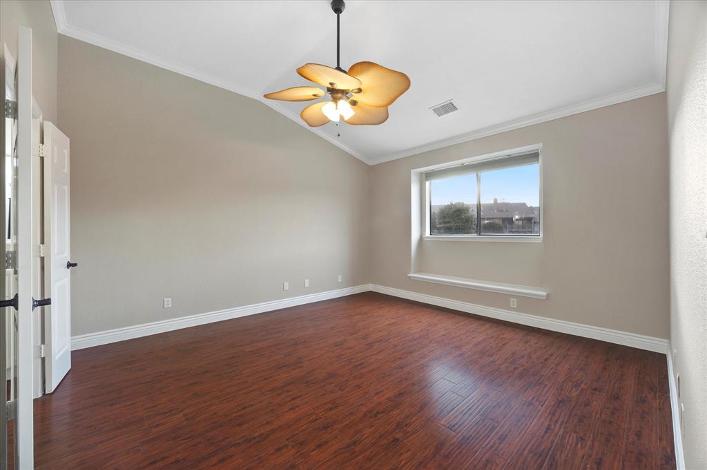 1908 Signal Ridge Place Rockwall, TX 75032 - Photo 10 of 28 a view of an empty room with wooden floor and a window