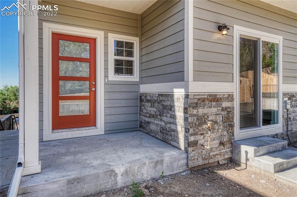 840 Promontory Rock Grove Colorado Springs, CO 80905 - Photo 1 of 11 front view of a brick house with large windows