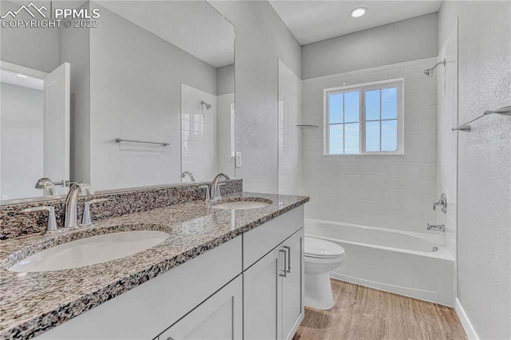 840 Promontory Rock Grove Colorado Springs, CO 80905 - Photo 11 of 11 a bathroom with a granite countertop sink toilet and shower