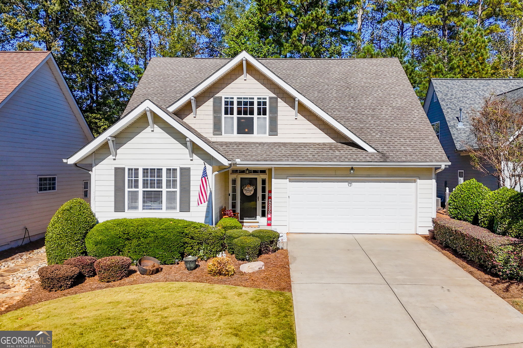 a front view of a house with a yard and garage