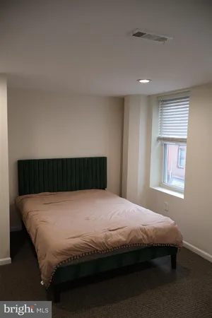 a bed sitting in a room next to a window