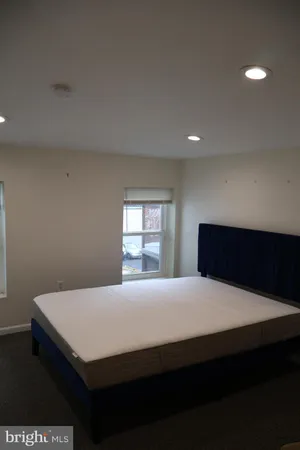 a bedroom with a bed and window