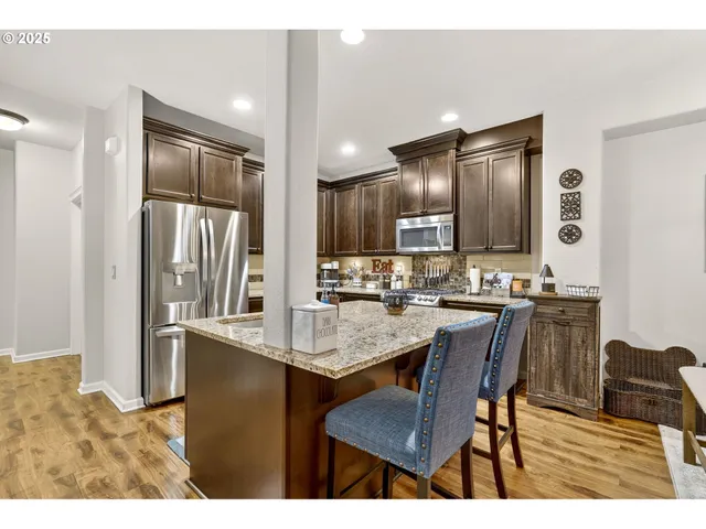 a kitchen with stainless steel appliances granite countertop a stove and a microwave
