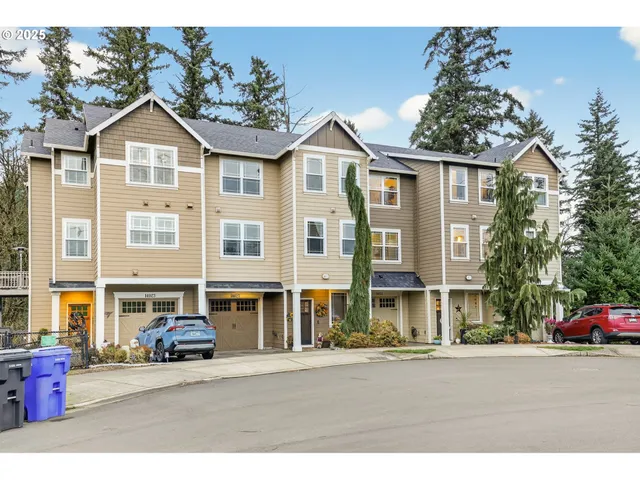 a front view of a residential apartment building with a yard