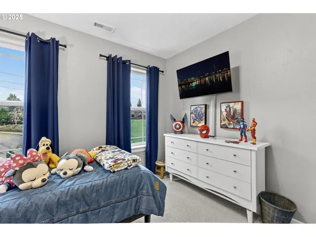 a bathroom with a sink a toilet a mirror and shower curtain