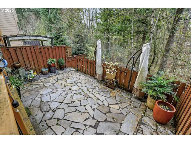 a view of a chair and table in the backyard