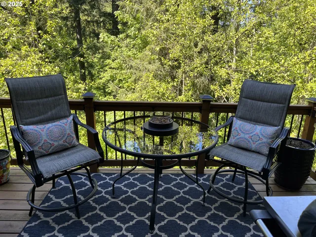 a backyard of a house with table and chairs