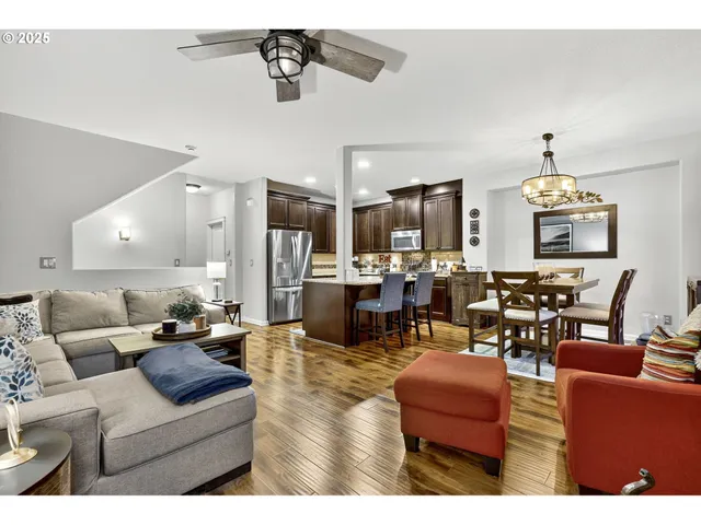 a living room with stainless steel appliances kitchen island granite countertop furniture and a view of kitchen